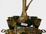 a gold and green vase and cups on a tray