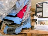 a pile of luggage sitting on top of a wooden pallet