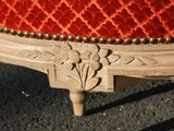 a close up of a chair with a red upholstered upholstered seat