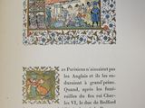an open book with a picture of a woman and a man in a room