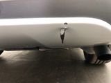 a close up of a car ' s bumper with a hole in it