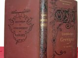 an old book sitting on top of a red cloth covered table
