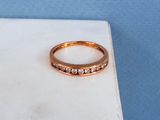 an image of a gold ring with pink stones