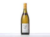 a bottle of white wine sitting on top of a table