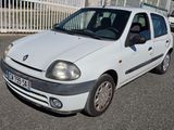 a small white car that is parked in a parking lot