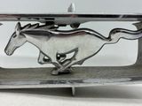 a silver horse belt buckle with a horse running on it