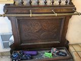 a wooden bench that has a bunch of items in it
