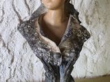 a bust of a woman wearing a scarf on a table