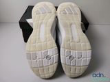 the soles of a pair of white shoes on a white surface
