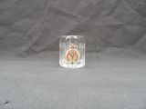 a small glass candle holder on a black background
