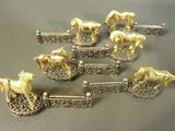 five gold horses that are sitting on a table
