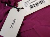 a close up of a purple dress with a tag on it