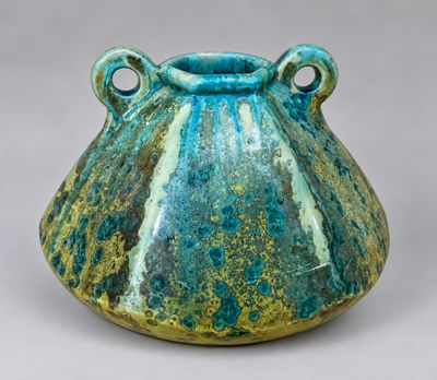 a blue and green vase with two handles on it
