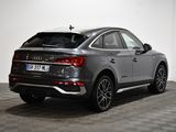 the rear end of a grey audi qx parked in a room