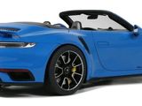 a blue porsche sports car on a white background with the top down
