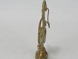 brass figurine of a woman holding a bottle of wine