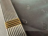 a close up of a gold and silver watch on a table