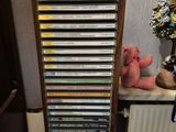 a tall wooden cabinet with many dvds on it