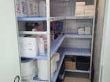 a small room with shelves and bins in it