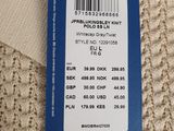 the label on the back of a sweater is attached to a tag