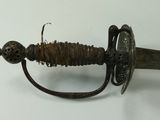 a very old looking sword that is laying on a table