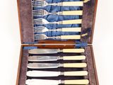 a wooden case with a set of silverware in it