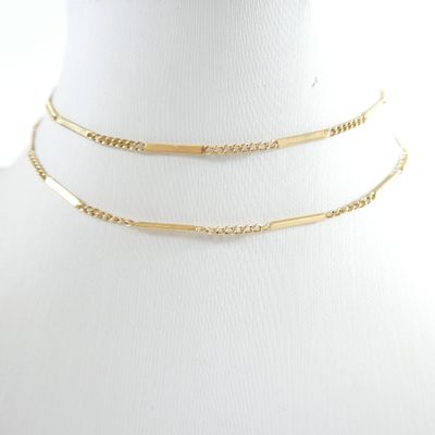 a close up of a mannequin with a gold chain on it