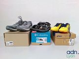 three pairs of shoes sitting on top of a box