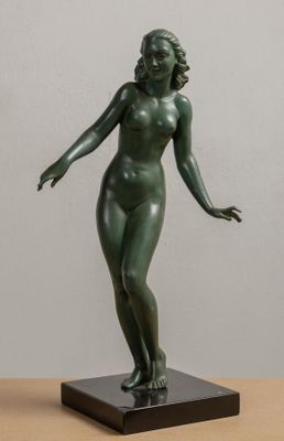 statue of a woman standing on a base on a table