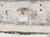 a close up of a piece of metal with a tag attached to it