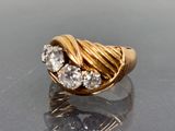 an image of a gold ring with three diamonds