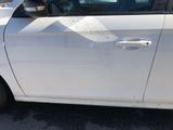 a white car with a sticker on the side of it ' s door
