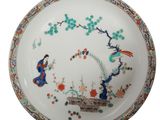 a white plate with a design of birds and flowers on it