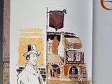 an open book with a drawing of a man in a top hat