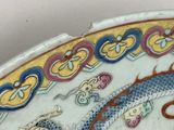a close up of a decorative plate with a dragon on it