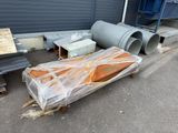 a lot of junk on the ground outside of a building