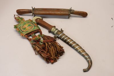 a knife and a wooden handle on a white surface