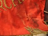a close up of a red cloth with gold writing on it