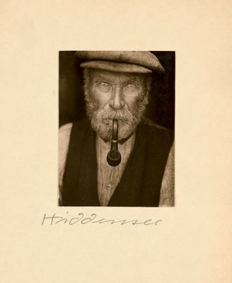 an old photo of a man with a pipe in his mouth