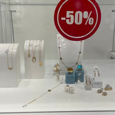 a red sign that says 50 % on it in a display case