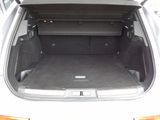 a trunk of a white car with its doors open
