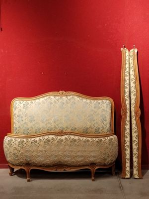 a couch and a bed in a room with a red wall