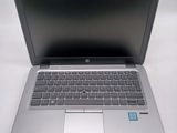 a silver laptop with a blue sticker on it