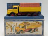 a yellow and red toy truck sitting on top of a box