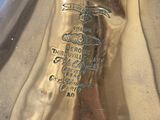 a gold vase that has a label on it