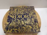 christian dior book on a cutting board
