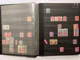a book with stamps on it and a bookmark on the cover