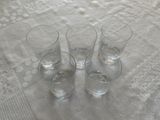 three glasses of water sitting on a table with a white tablecloth