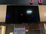a television mounted above a glass display case in a store