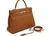 a brown leather handbag with gold hardware and strap
